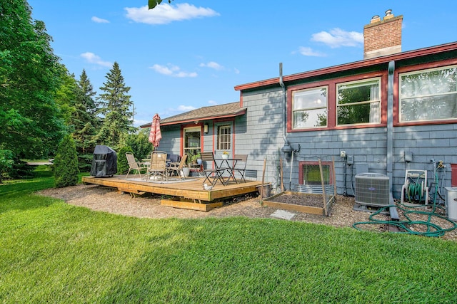 2845 Pittsfield Blvd, Ann Arbor, MI 48104 - rear view of house with central air condition unit, a lawn, a deck, and a chimney