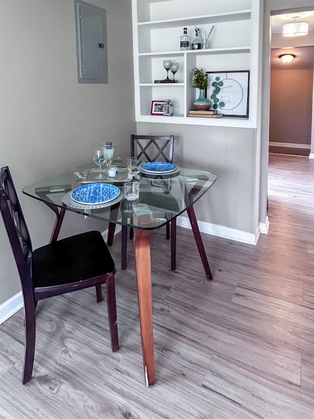1492 Webber Ave, Burton, MI 48529 - dining room with electric panel, wood finished floors, baseboards, and built in features