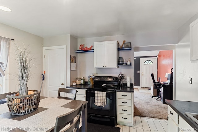17710 Trinity St, Detroit, MI 48219 - kitchen with electric range, open shelves, dark countertops, white cabinetry, and light wood finished floors
