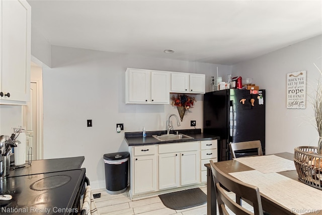 17710 Trinity St, Detroit, MI 48219 - kitchen featuring a sink, black appliances, dark countertops, white cabinets, and baseboards