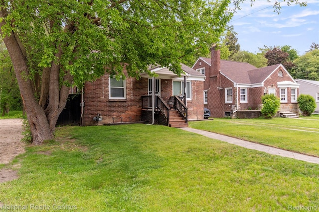 17710 Trinity St, Detroit, MI 48219 - view of front of house featuring a chimney, a front lawn, and brick siding