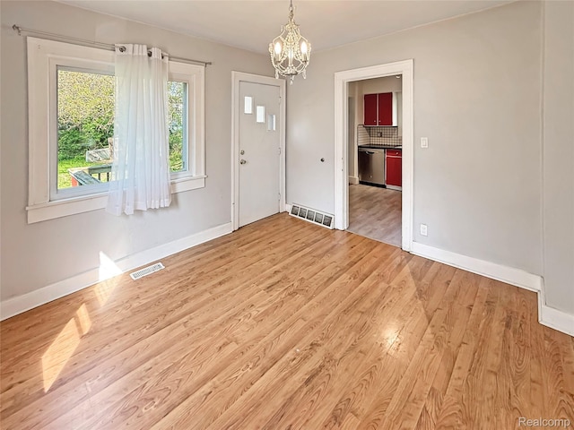 1408 Lincoln Dr, Flint, MI 48503 - entrance foyer with a chandelier, wood finished floors, and baseboards