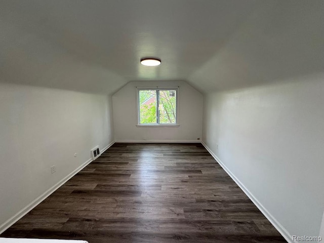 6117 Oldtown St S, Detroit, MI 48224 - bonus room with lofted ceiling, dark wood-style flooring, and baseboards