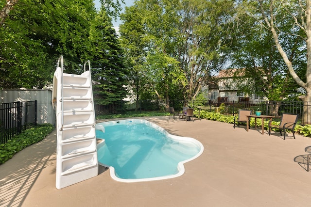 9869 Dartmoor Cir, Van Buren, MI 48111 - view of pool with a fenced backyard, a water slide, and a patio area
