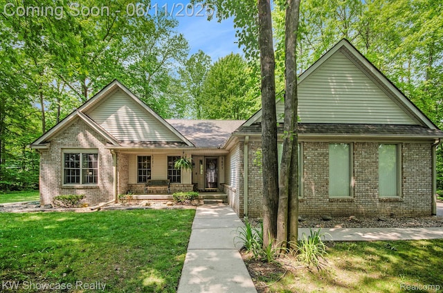 3675 S Commerce Rd, Commerce Twp, MI 48390 - single story home with covered porch, brick siding, and a front lawn