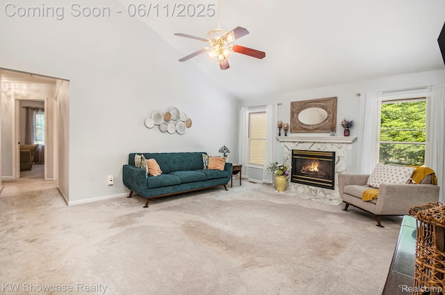 3675 S Commerce Rd, Commerce Twp, MI 48390 - living area featuring high vaulted ceiling, carpet floors, a ceiling fan, a premium fireplace, and baseboards