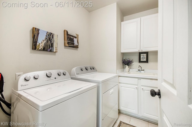 3675 S Commerce Rd, Commerce Twp, MI 48390 - laundry area featuring washer and clothes dryer, cabinet space, and light tile patterned floors