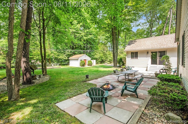 3675 S Commerce Rd, Commerce Twp, MI 48390 - view of green lawn with a fire pit, a patio area, and an outdoor structure