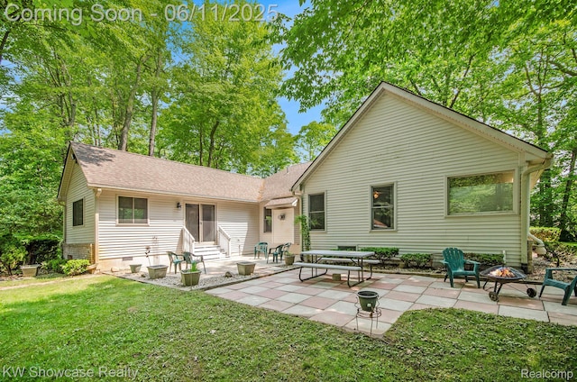 3675 S Commerce Rd, Commerce Twp, MI 48390 - back of property with entry steps, a lawn, a fire pit, and a patio