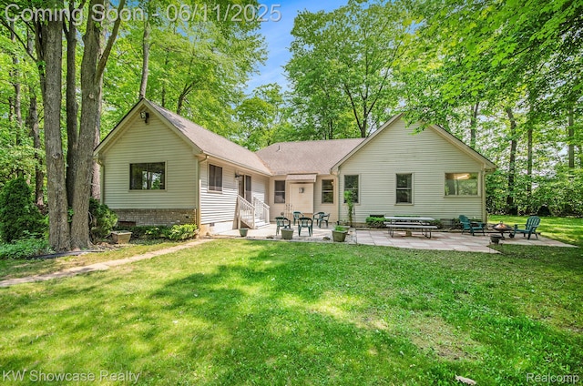 3675 S Commerce Rd, Commerce Twp, MI 48390 - back of property with a patio, a fire pit, entry steps, and a yard