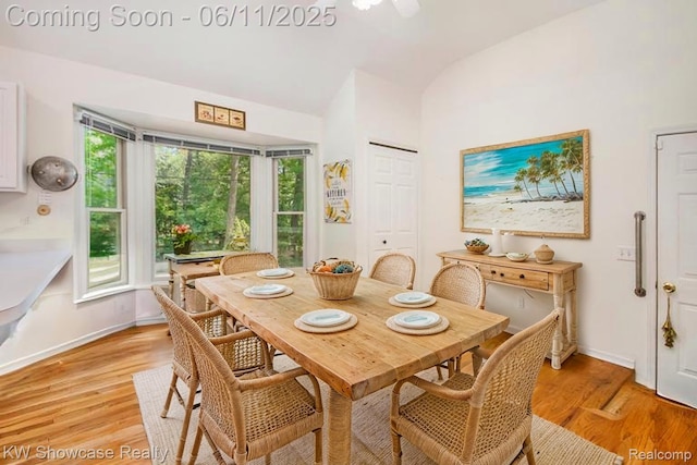 3675 S Commerce Rd, Commerce Twp, MI 48390 - dining space with light wood-type flooring, vaulted ceiling, and baseboards