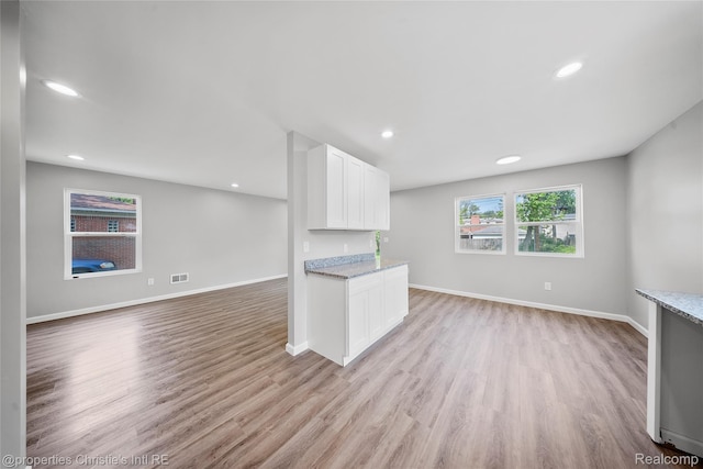 22114 Pleasant Ave, Eastpointe, MI 48021 - kitchen with white cabinets, light stone counters, light wood-type flooring, baseboards, and recessed lighting