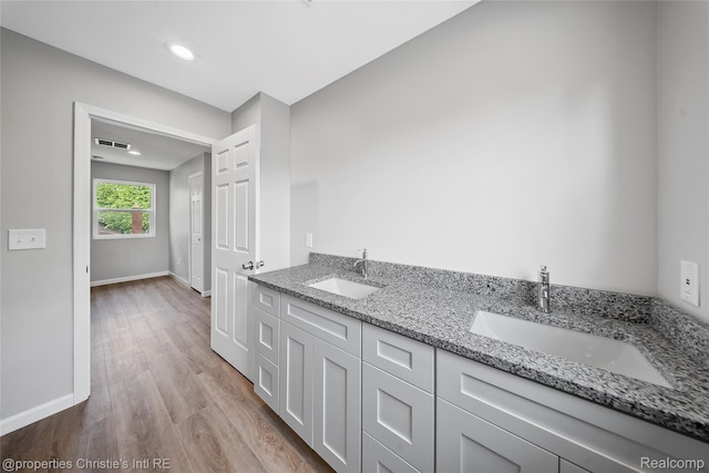 22114 Pleasant Ave, Eastpointe, MI 48021 - bathroom with wood finished floors, double vanity, and baseboards