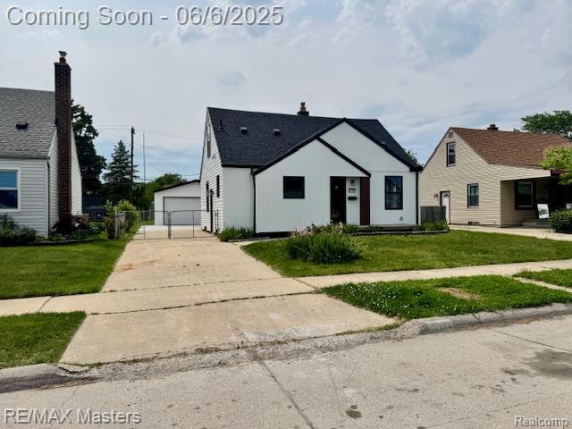 17772 Clark St, Riverview, MI 48193 - view of front of home with a front lawn, an outbuilding, and a detached garage