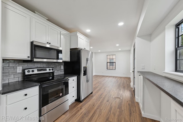 17772 Clark St, Riverview, MI 48193 - kitchen featuring appliances with stainless steel finishes, dark countertops, healthy amount of natural light, and recessed lighting