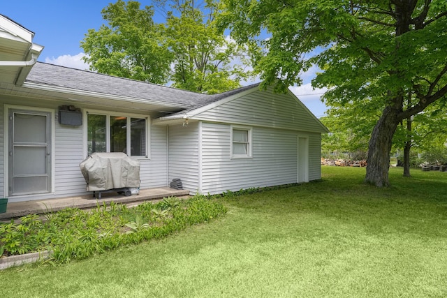 817 Cherry Ave, Big Rapids, MI 49307 - view of side of home with a shingled roof and a lawn