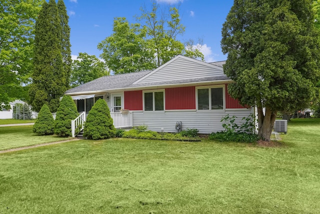 817 Cherry Ave, Big Rapids, MI 49307 - view of front of house featuring a front lawn, cooling unit, and a shingled roof