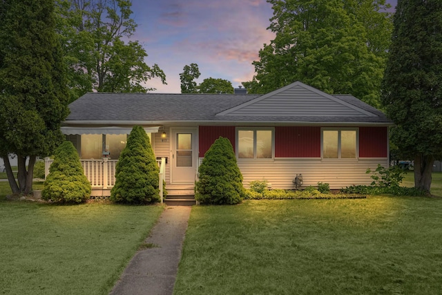 817 Cherry Ave, Big Rapids, MI 49307 - view of front of property featuring a front yard, roof with shingles, and a chimney