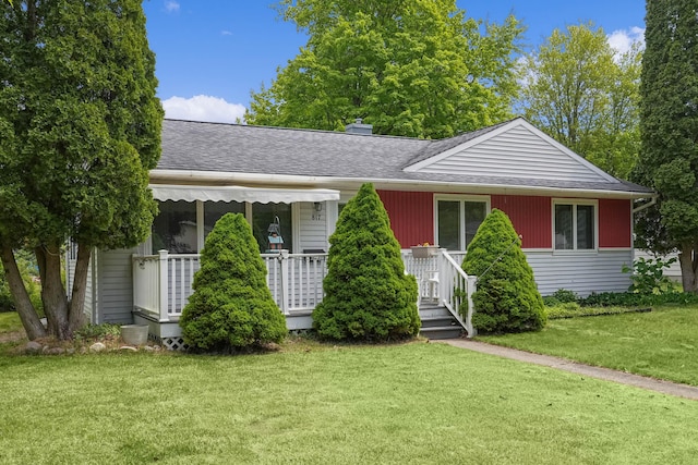 817 Cherry Ave, Big Rapids, MI 49307 - view of front of property featuring a shingled roof, a front yard, and a chimney