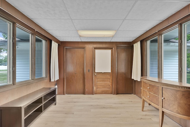 817 Cherry Ave, Big Rapids, MI 49307 - hallway with wood walls, light wood-style flooring, and a paneled ceiling