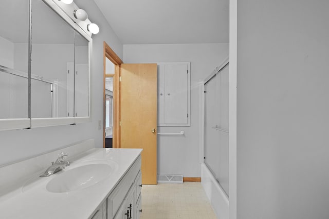 817 Cherry Ave, Big Rapids, MI 49307 - full bathroom featuring vanity, tile patterned floors, shower / bath combination with glass door, and baseboards