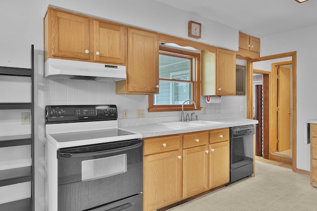 817 Cherry Ave, Big Rapids, MI 49307 - kitchen featuring black appliances, under cabinet range hood, a sink, light countertops, and backsplash