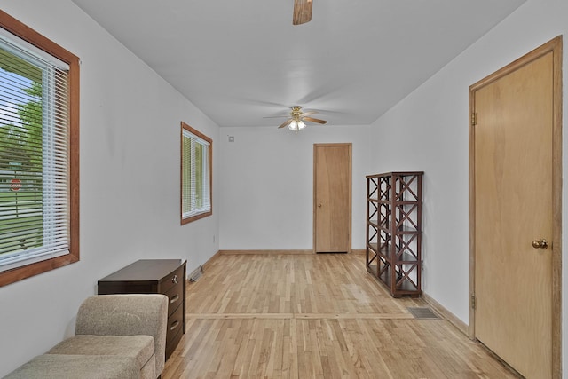 817 Cherry Ave, Big Rapids, MI 49307 - unfurnished living room with a ceiling fan, light wood-style floors, and baseboards