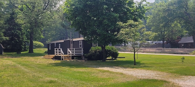 728 Crystal Ln, Mears, MI 49436 - view of grassy yard featuring a wooden deck