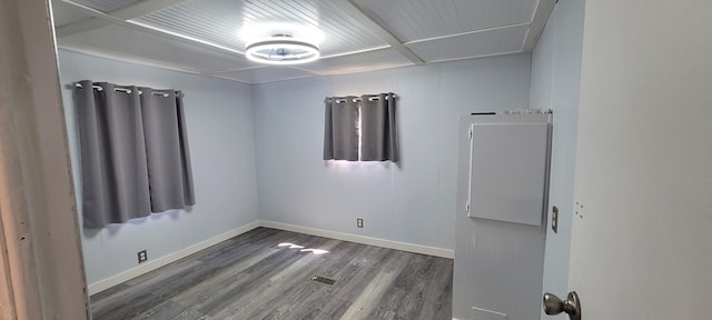 728 Crystal Ln, Mears, MI 49436 - spare room featuring baseboards and wood finished floors