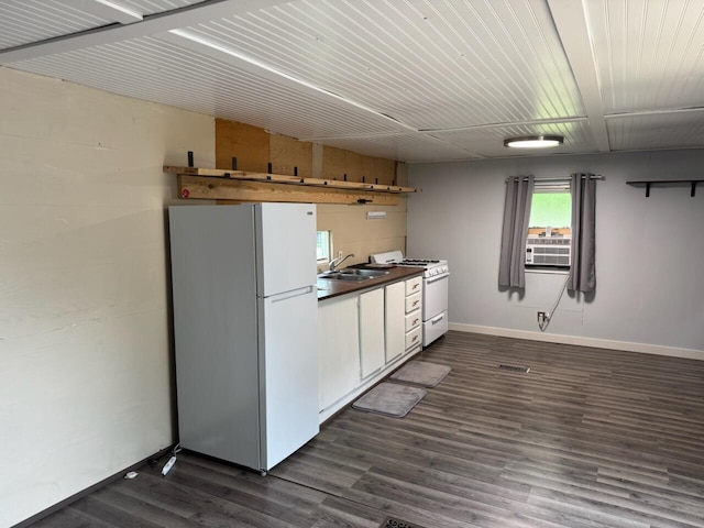 728 Crystal Ln, Mears, MI 49436 - kitchen with white appliances, dark wood-type flooring, baseboards, a sink, and white cabinetry