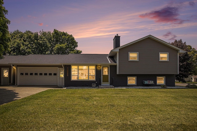 802 Kay St, Otsego, MI 49078 - tri-level home with a chimney, a garage, a lawn, and concrete driveway