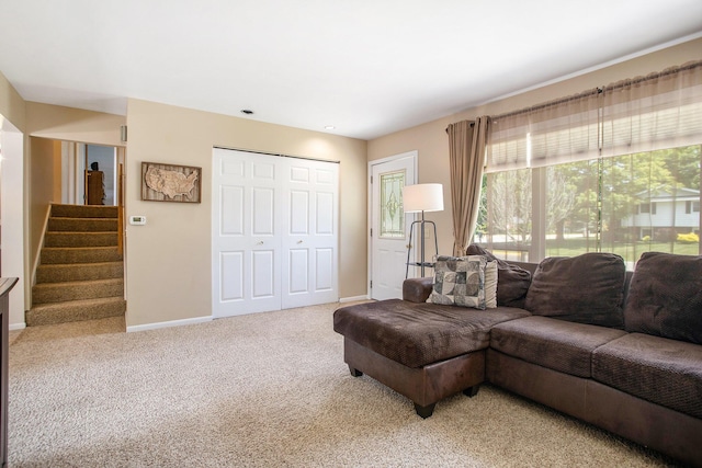 802 Kay St, Otsego, MI 49078 - living area featuring light carpet, baseboards, and stairway