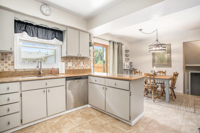 802 Kay St, Otsego, MI 49078 - kitchen featuring stainless steel dishwasher, a sink, a peninsula, backsplash, and decorative light fixtures