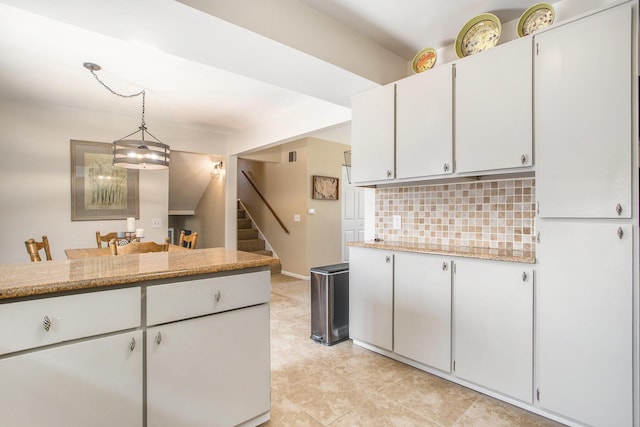 802 Kay St, Otsego, MI 49078 - kitchen featuring backsplash, hanging light fixtures, white cabinets, and light tile patterned floors