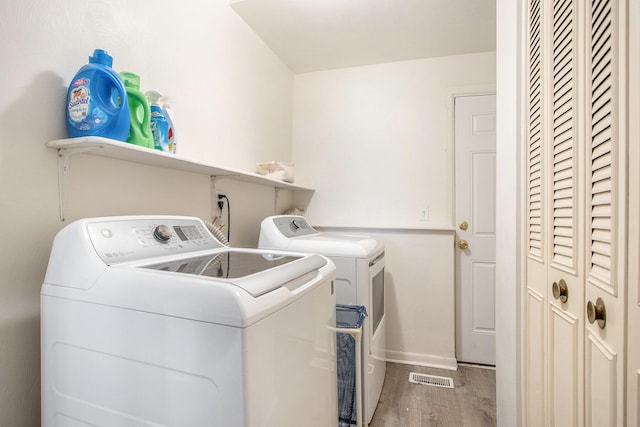 802 Kay St, Otsego, MI 49078 - laundry room featuring independent washer and dryer, wood finished floors, and baseboards