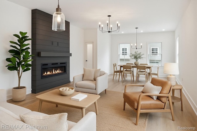 1689 Pinecroft Ln, Howell, MI 48855 - living area featuring a chandelier, light wood-type flooring, a large fireplace, and recessed lighting
