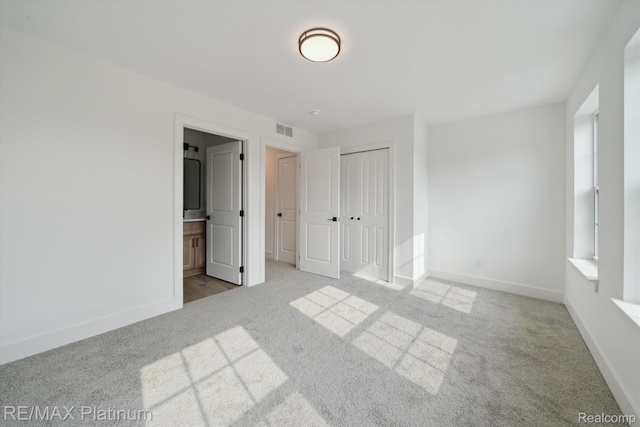 1689 Pinecroft Ln, Howell, MI 48855 - unfurnished bedroom featuring carpet flooring, a closet, and ensuite bathroom