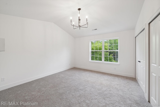 1689 Pinecroft Ln, Howell, MI 48855 - unfurnished bedroom with a chandelier, vaulted ceiling, and carpet floors