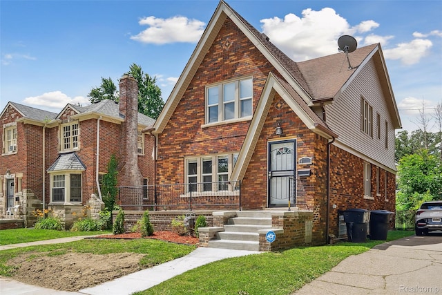 4835 Bedford St, Detroit, MI 48224 - view of front of house featuring a front lawn, brick siding, a chimney, and roof with shingles