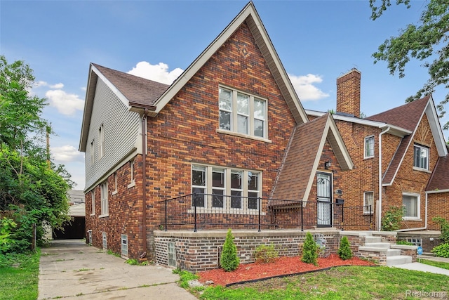 4835 Bedford St, Detroit, MI 48224 - english style home with brick siding, a chimney, and roof with shingles