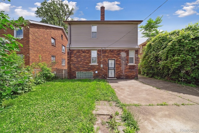 4835 Bedford St, Detroit, MI 48224 - rear view of property with a chimney and brick siding