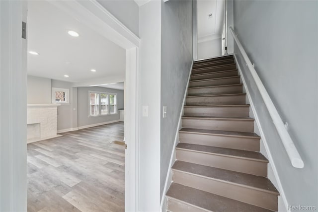 4835 Bedford St, Detroit, MI 48224 - stairway with wood finished floors, recessed lighting, baseboards, and a fireplace