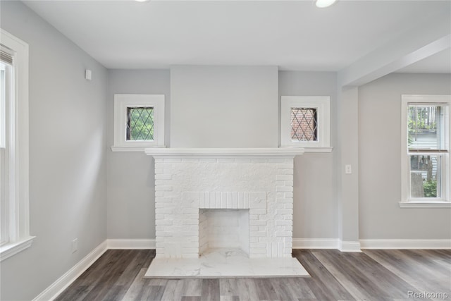 4835 Bedford St, Detroit, MI 48224 - unfurnished living room featuring wood finished floors, baseboards, a brick fireplace, and recessed lighting