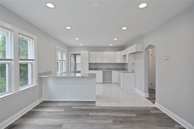 4835 Bedford St, Detroit, MI 48224 - kitchen with recessed lighting, baseboards, white cabinets, a peninsula, and arched walkways