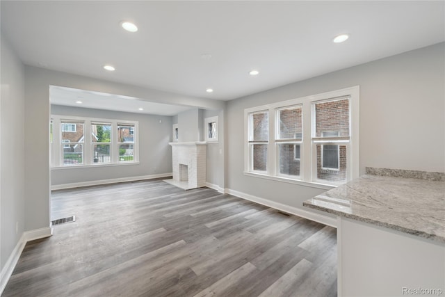 4835 Bedford St, Detroit, MI 48224 - unfurnished living room with recessed lighting, wood finished floors, baseboards, and a brick fireplace
