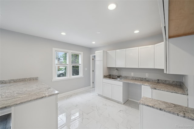 4835 Bedford St, Detroit, MI 48224 - kitchen with a sink, white cabinetry, recessed lighting, baseboards, and light marble finish floors