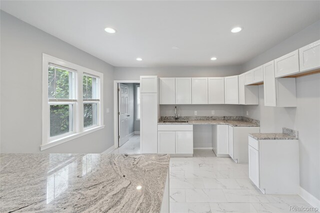 4835 Bedford St, Detroit, MI 48224 - kitchen featuring a sink, recessed lighting, light marble finish flooring, light stone counters, and white cabinets
