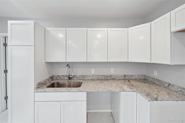 4835 Bedford St, Detroit, MI 48224 - kitchen with a sink, white cabinets, marble finish floors, and light stone countertops