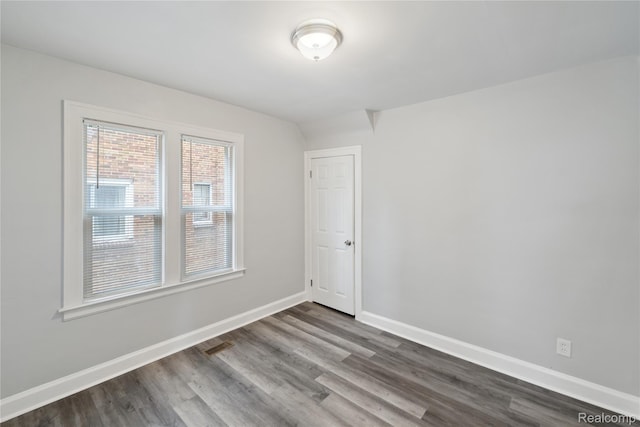 4835 Bedford St, Detroit, MI 48224 - unfurnished room with dark wood-style flooring and baseboards