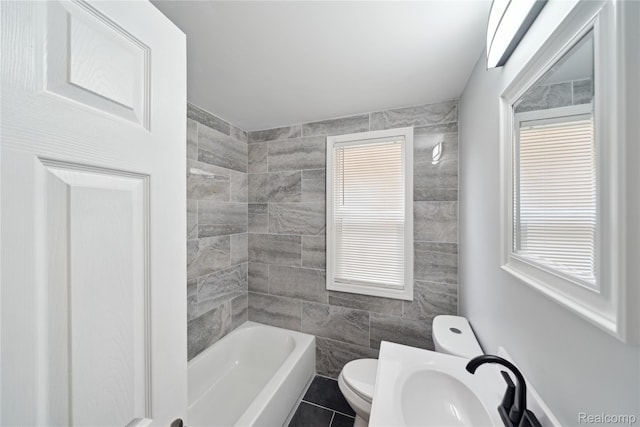 4835 Bedford St, Detroit, MI 48224 - bathroom with toilet, a sink, tile walls, tile patterned floors, and tub / shower combination
